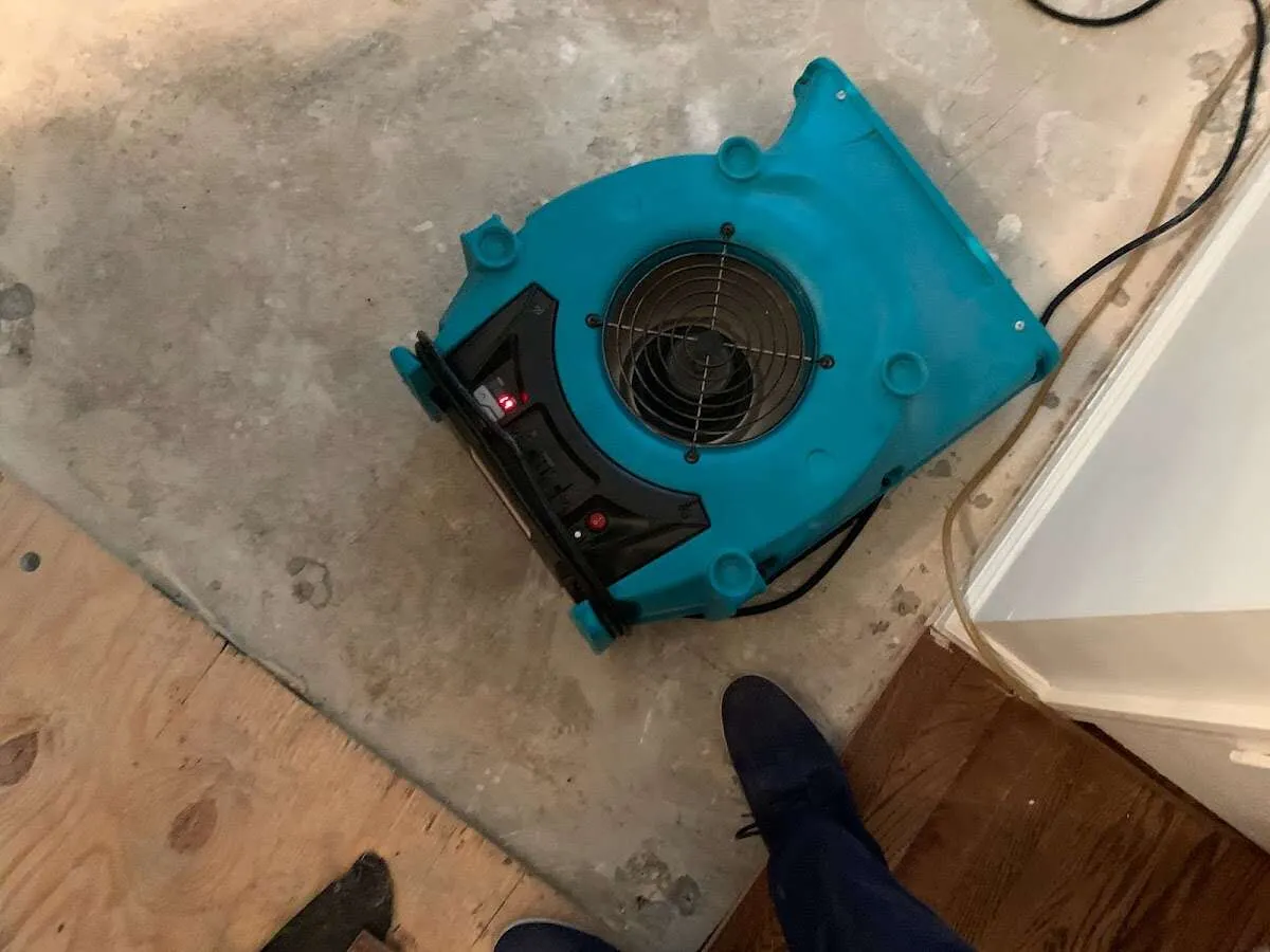 Air mover drying subfloor during Commercial Water Damage Restoration in Silvis